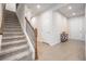 Bright entryway with carpeted stairs and tile flooring at 7878 Greenway Ave, Wesley Chapel, FL 33544