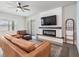 Spacious living room featuring a modern fireplace and built-in shelving at 7878 Greenway Ave, Wesley Chapel, FL 33544