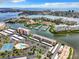 Aerial view of waterfront community with marina, pool, and tennis courts at 7930 Sun Island S Dr # 305, South Pasadena, FL 33707