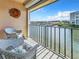 Relaxing balcony with water views and seating for two at 7930 Sun Island S Dr # 305, South Pasadena, FL 33707