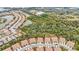 Aerial view of townhouses nestled amongst lush greenery at 8332 Enclave Way # 101, Sarasota, FL 34243