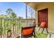 Screened balcony with outdoor furniture and nature views at 8332 Enclave Way # 101, Sarasota, FL 34243