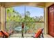 Relaxing balcony with outdoor furniture and tranquil nature views at 8332 Enclave Way # 101, Sarasota, FL 34243