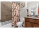 Bathroom with tub, toilet, and flamingo shower curtain at 8332 Enclave Way # 101, Sarasota, FL 34243