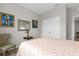 Bedroom with a full-size bed, chair, and double doors at 8332 Enclave Way # 101, Sarasota, FL 34243