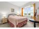 Bedroom with a full-size bed and a round side table at 8332 Enclave Way # 101, Sarasota, FL 34243