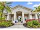 Community clubhouse entrance with landscaping and inviting atmosphere at 8332 Enclave Way # 101, Sarasota, FL 34243