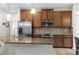 Modern kitchen with stainless steel appliances and wood cabinets at 8332 Enclave Way # 101, Sarasota, FL 34243