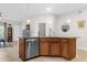 Modern kitchen island with granite countertop and stainless steel dishwasher at 8332 Enclave Way # 101, Sarasota, FL 34243