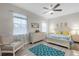 Main bedroom with a dresser, seating area, and ceiling fan at 8332 Enclave Way # 101, Sarasota, FL 34243