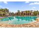 Inviting community pool with surrounding lush landscaping at 8332 Enclave Way # 101, Sarasota, FL 34243