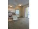 Open living room and kitchen area with carpet at 8800 Bay Pines Blvd # 220, St Petersburg, FL 33709