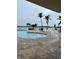 Refreshing kidney-shaped pool with patio and water views at 8800 Bay Pines Blvd # 220, St Petersburg, FL 33709