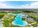 Aerial view of Crystal Lagoon community, showing lagoon and surrounding homes at 9228 Forge Breeze Loop Loop, Wesley Chapel, FL 33545