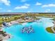 Aerial view of Crystal Lagoon amenity with expansive lagoon and water features at 9228 Forge Breeze Loop Loop, Wesley Chapel, FL 33545