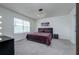 Bright bedroom with a king-size bed, window, and wall art at 9228 Forge Breeze Loop Loop, Wesley Chapel, FL 33545