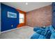 Multi-purpose room with a blue accent wall and sectional sofa at 9228 Forge Breeze Loop Loop, Wesley Chapel, FL 33545