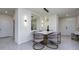 Elegant dining room features marble table and grey chairs at 9228 Forge Breeze Loop Loop, Wesley Chapel, FL 33545