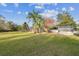 Large backyard with home, screened patio and palm trees at 9232 Brindlewood Dr, Odessa, FL 33556