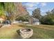 Backyard with fire pit, greenhouse and fenced-in area at 9232 Brindlewood Dr, Odessa, FL 33556