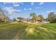 Large backyard with home, screened patio and palm trees at 9232 Brindlewood Dr, Odessa, FL 33556