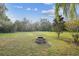 Backyard with firepit and expansive grassy area at 9232 Brindlewood Dr, Odessa, FL 33556