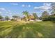 Large backyard with home, screened patio and palm trees at 9232 Brindlewood Dr, Odessa, FL 33556