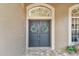 Double front doors with arched entryway and wreaths at 9232 Brindlewood Dr, Odessa, FL 33556