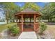 Wooden gazebo with a bench, perfect for relaxing at 9232 Brindlewood Dr, Odessa, FL 33556