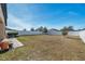 Spacious backyard with grassy area and white vinyl fence at 954 Old Windsor Way, Spring Hill, FL 34609