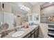 Double vanity bathroom with granite countertops and a large shower at 954 Old Windsor Way, Spring Hill, FL 34609