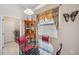 Bright breakfast nook features a glass table and red chairs, adjacent to laundry at 954 Old Windsor Way, Spring Hill, FL 34609