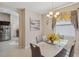 Bright dining room with a modern glass table and kitchen view at 954 Old Windsor Way, Spring Hill, FL 34609