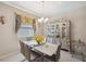 Elegant dining room with a glass-top table and ornate hutch at 954 Old Windsor Way, Spring Hill, FL 34609