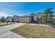 Nice curb appeal! This lovely one-story home features a two-car garage and well-manicured lawn at 954 Old Windsor Way, Spring Hill, FL 34609