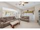 Relaxing living room with sectional sofa and view into dining area at 954 Old Windsor Way, Spring Hill, FL 34609