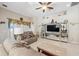 Open living area featuring a large TV and comfortable seating at 954 Old Windsor Way, Spring Hill, FL 34609