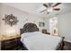 Spacious main bedroom with ceiling fan, dresser, and ensuite bathroom at 954 Old Windsor Way, Spring Hill, FL 34609