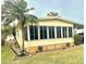 Side view of a yellow single-wide manufactured home with landscaping at 9790 66Th N St # 425, Pinellas Park, FL 33782