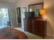 Bedroom with dresser, TV, and access to private balcony at 103 Old Mill Pond Rd, Palm Harbor, FL 34683