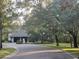 Two-car garage home with a tree-lined driveway at 103 Old Mill Pond Rd, Palm Harbor, FL 34683