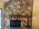 Stone fireplace with wood mantel and black metal screen at 103 Old Mill Pond Rd, Palm Harbor, FL 34683