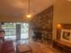 Living room with a stone fireplace, hardwood floors, and access to a deck at 103 Old Mill Pond Rd, Palm Harbor, FL 34683