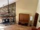 Living room with stone fireplace and hardwood floors at 103 Old Mill Pond Rd, Palm Harbor, FL 34683