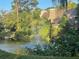 Water feature with fountain and reflection of condo building at 103 Old Mill Pond Rd, Palm Harbor, FL 34683