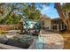 Relaxing backyard oasis featuring a patio, seating area, and lush landscaping at 1030 Charles St, Clearwater, FL 33755