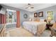 King-size bed, window seating, and ceiling fan at 1030 Charles St, Clearwater, FL 33755