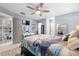 Bright bedroom with ceiling fan, built in shelving, and ensuite bathroom at 1030 Charles St, Clearwater, FL 33755