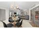 Bright dining area with glass table and four black chairs near kitchen at 1030 Charles St, Clearwater, FL 33755