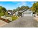 Charming light blue house with white picket fence, landscaping, and a two-car garage at 1030 Charles St, Clearwater, FL 33755